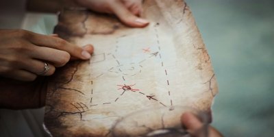 Treasure Hunt by Natalie_Unsplash Ripped old brown map with 'x' marked. Girls hand holding map
