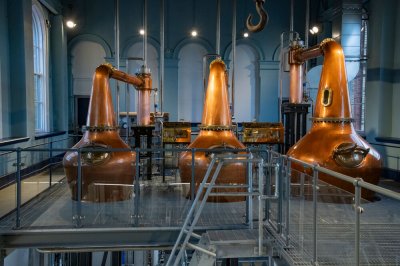 Titanic Distillers credit to chrishillphotographer three copper coloured whiskey vessels