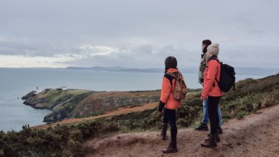 Howth Cliff Walk Courtesy Fionn McCann three people looking at the sea standing on a cliff path