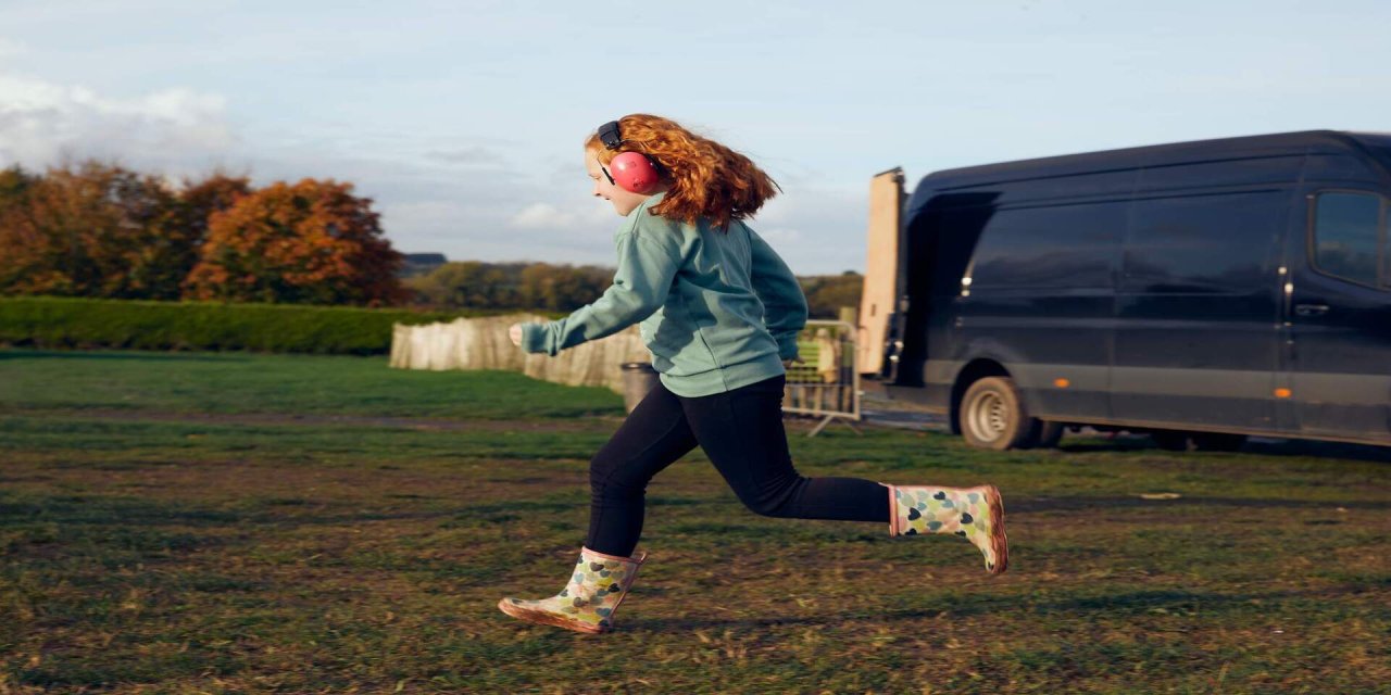 child running across field 