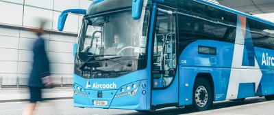 Aircoach express airport bus blue aircoach bus beside moving person