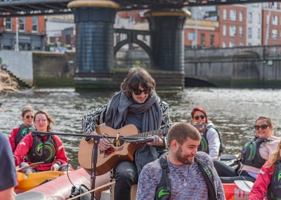 City Kayaking Music under the bridge  man playing guitar on water