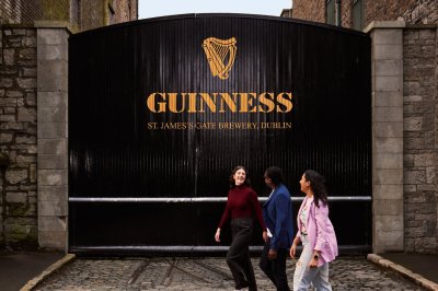 The Guinness Storehouse three people walking in front of the guinness storehouse tour