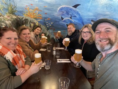Dublin Coastal Hikes & Pints Tour at Hidden Howth Experiences six people at a table with pints in their hand