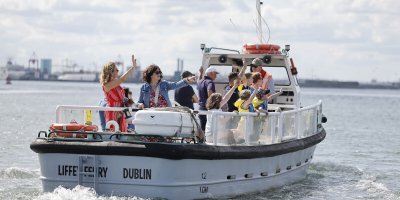 Old Liffey Ferry Boat Tour white boat on water with people on it